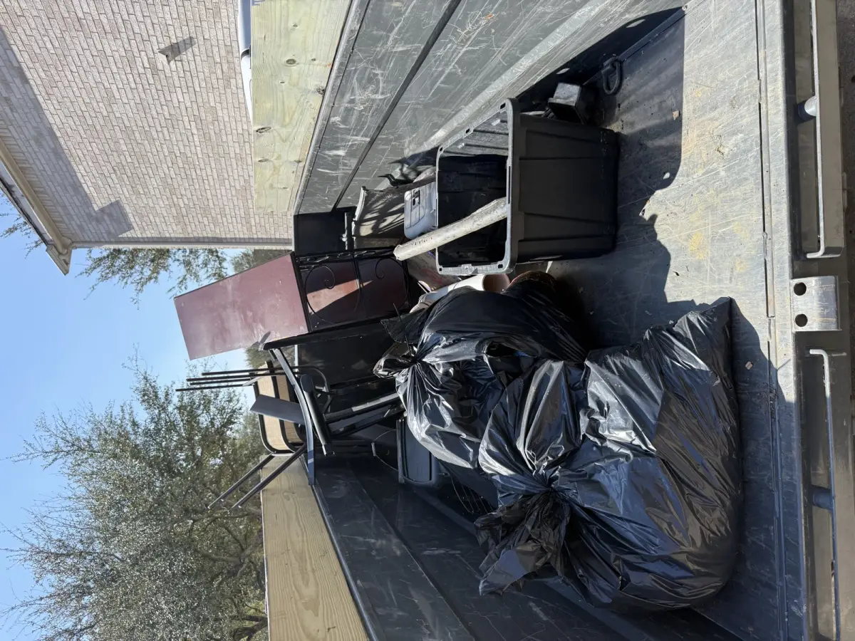 Daw's Junk Solutions trailer loaded with furniture and household items after a Houston area rental cleanout