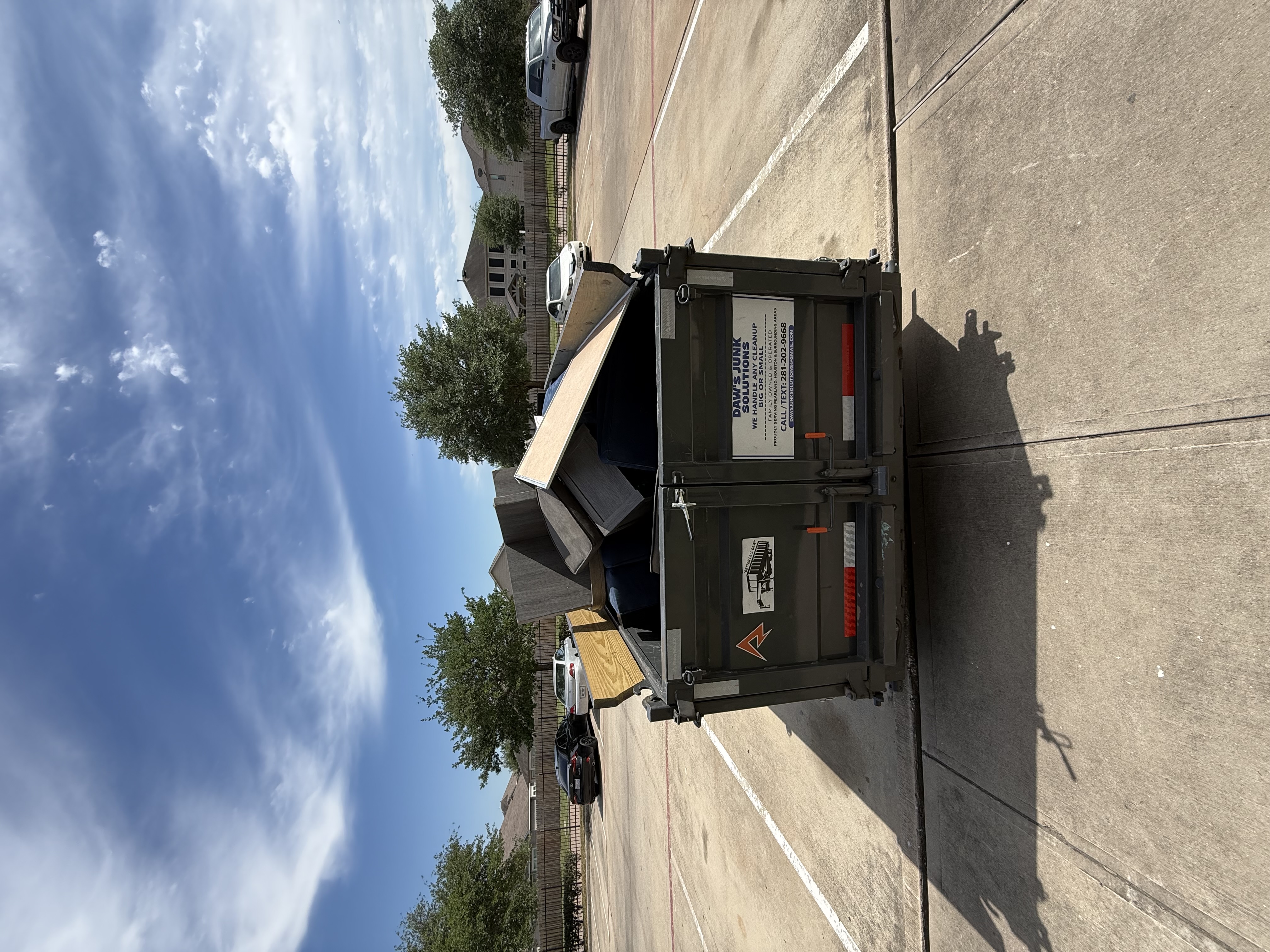 Commercial junk removal Pearland TX — Daw's trailer on job site