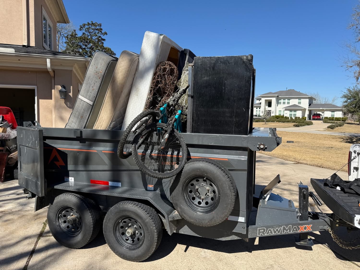 Home cleanout — RawMaxx trailer loaded with mattresses and appliances